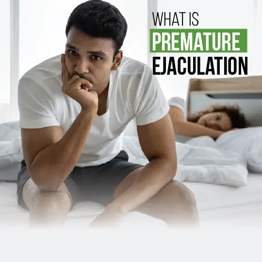 Man with premature ejaculation concerns sitting on bed looking worried