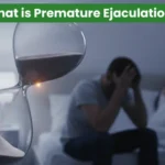 Couple in distress on bed with hourglass representing premature ejaculation and its relationship impact
